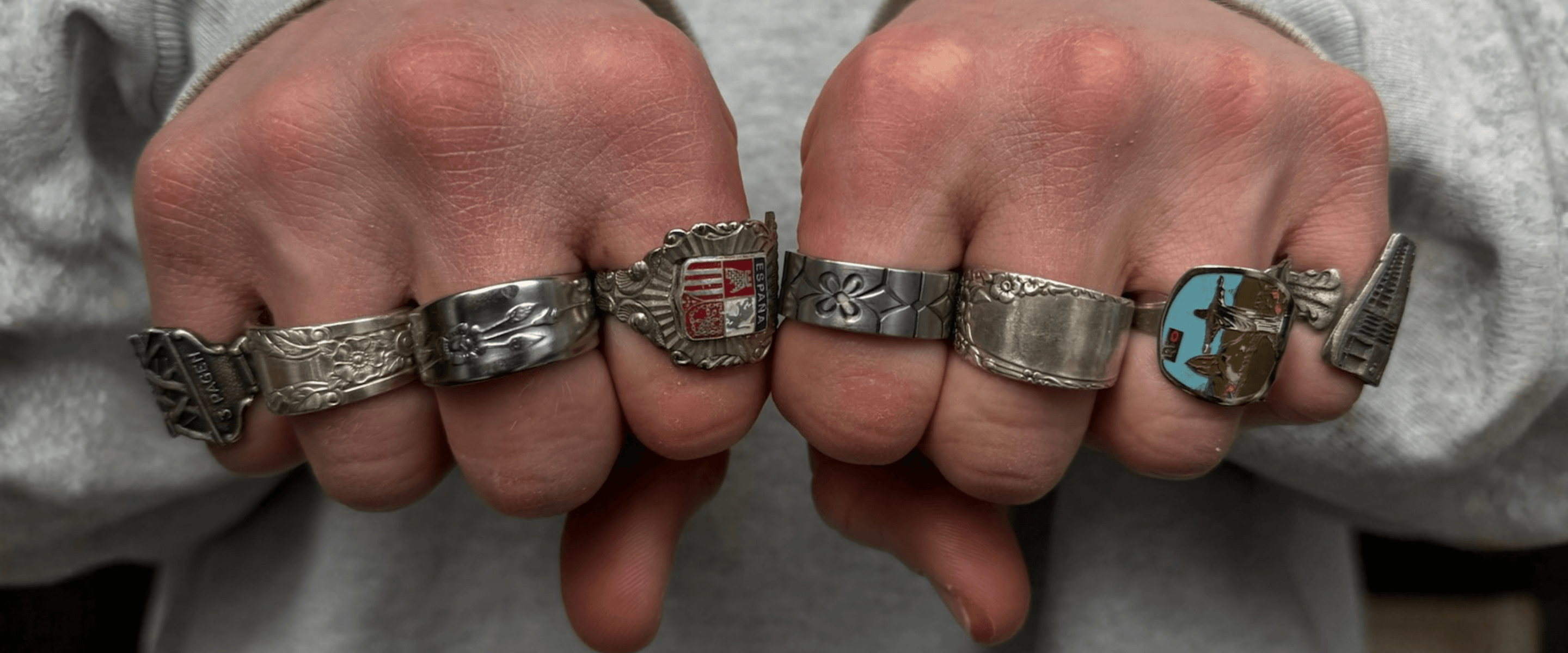 Two hands wearing unique handcrafted vintage spoon rings – one of a kind silver jewelry by Spoony Rings